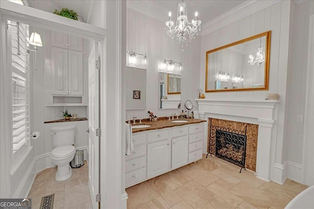 full bathroom featuring visible vents, double vanity, a high end fireplace, a sink, and crown molding