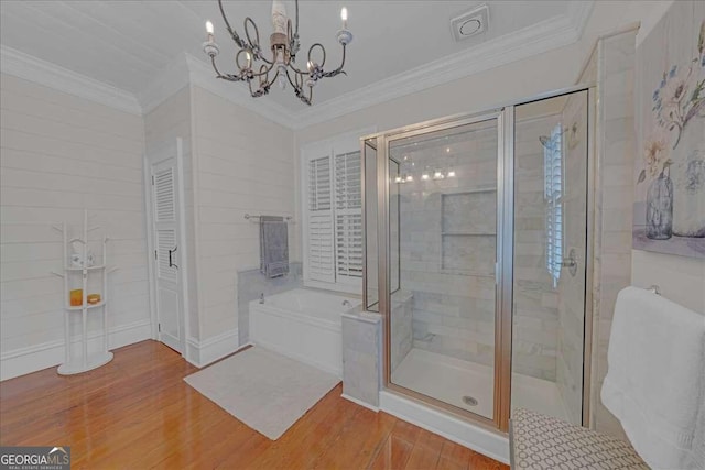 bathroom with separate shower and tub, hardwood / wood-style flooring, crown molding, and a notable chandelier