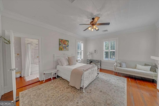 bedroom with ceiling fan, ornamental molding, and hardwood / wood-style flooring