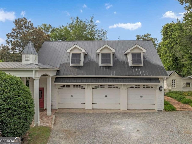 cape cod home with a garage