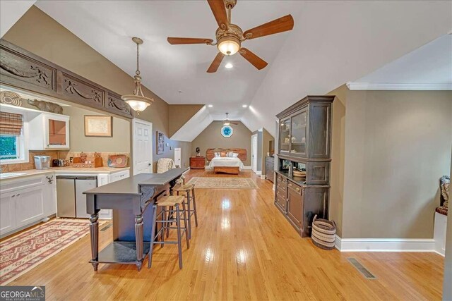 kitchen with dishwashing machine, light wood-style floors, and visible vents