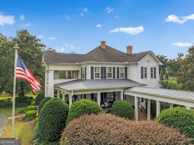 rear view of property with a chimney