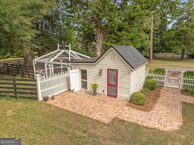 view of outbuilding featuring a gate and fence