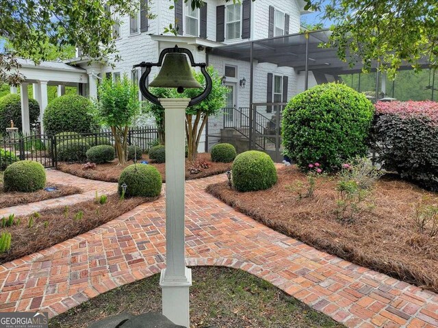 exterior space with a lanai and fence