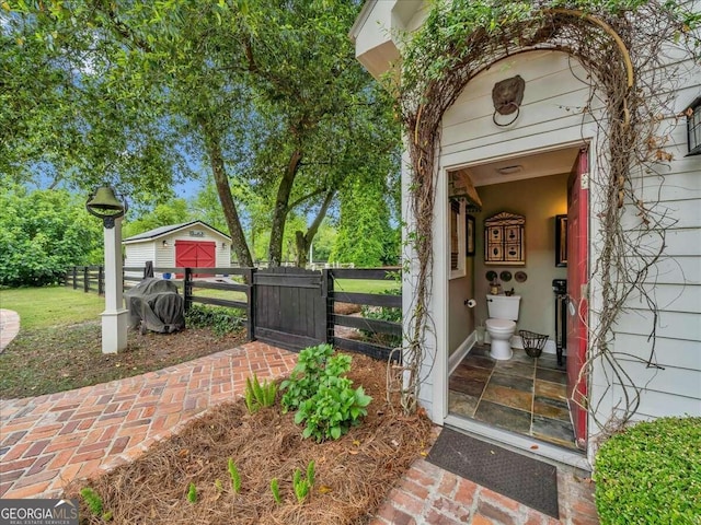 view of exterior entry with a gate and fence