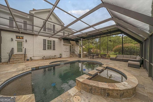 view of pool featuring entry steps, a patio, glass enclosure, and outdoor lounge area