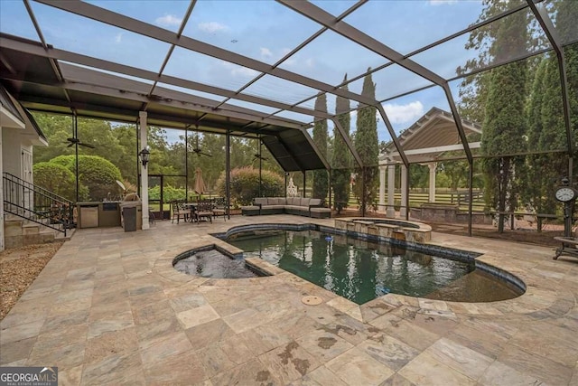 view of pool with an in ground hot tub, an outdoor living space, a patio, and a lanai