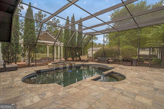 view of pool featuring a lanai, an in ground hot tub, and a patio