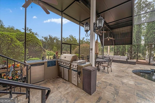 view of patio / terrace with area for grilling, ceiling fan, and an outdoor kitchen