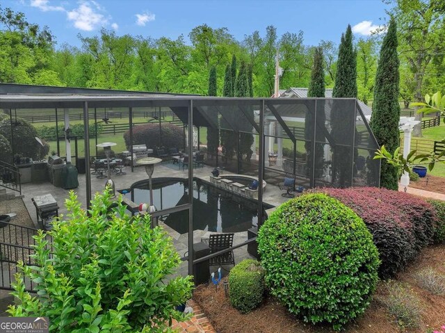 view of home's community with a pool and a patio area