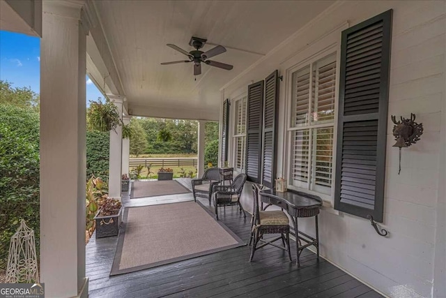 wooden deck with covered porch and ceiling fan