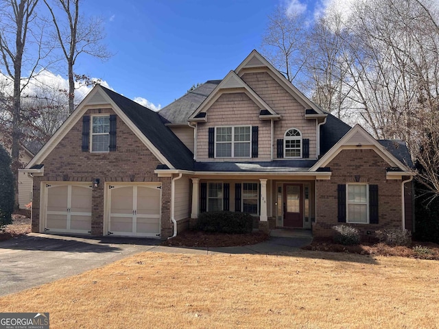 craftsman house featuring covered porch and a garage