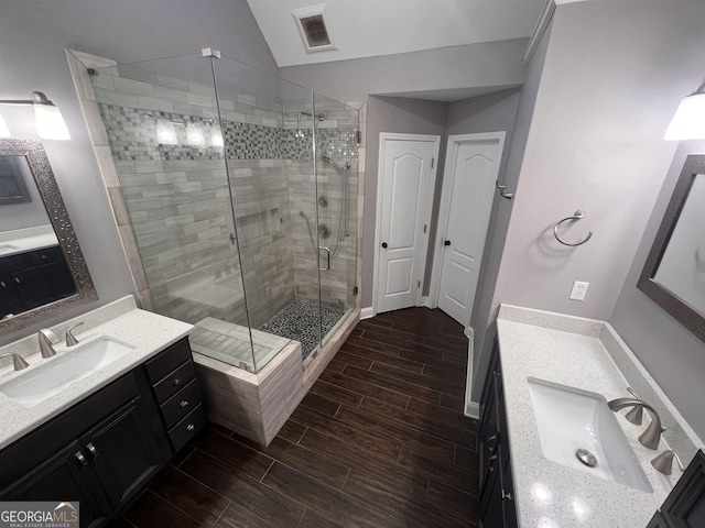 bathroom featuring vanity, an enclosed shower, and lofted ceiling