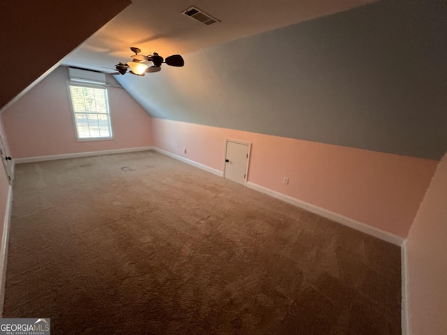 additional living space featuring carpet flooring and lofted ceiling