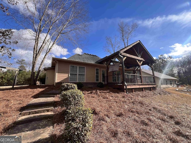 rear view of property with ceiling fan