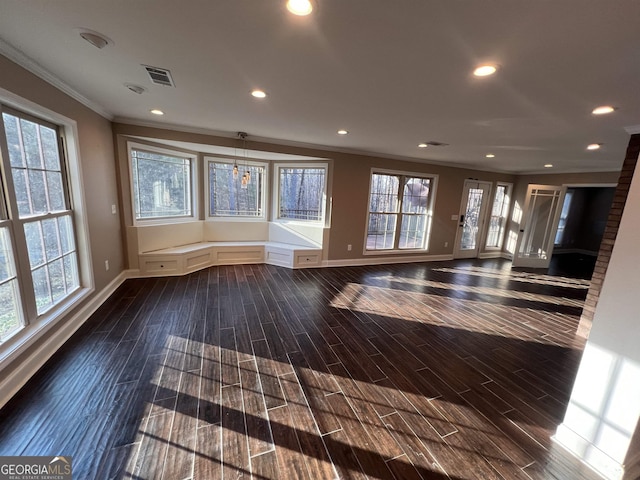 empty room with a healthy amount of sunlight and crown molding