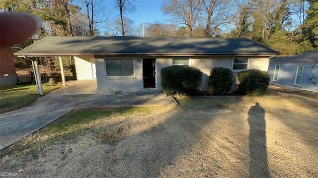 ranch-style house featuring a carport