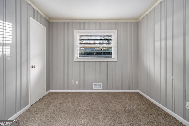 unfurnished room featuring carpet and ornamental molding