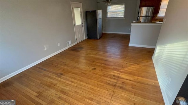 interior space with light hardwood / wood-style flooring and ceiling fan