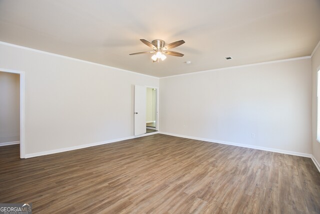 unfurnished room with hardwood / wood-style floors, ceiling fan, and crown molding