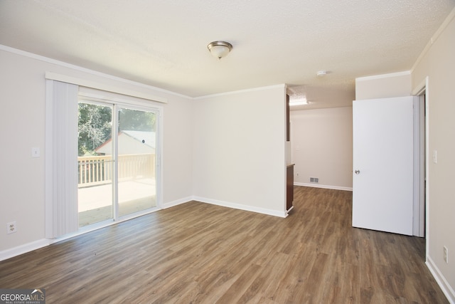 unfurnished room with a textured ceiling, dark hardwood / wood-style flooring, and ornamental molding