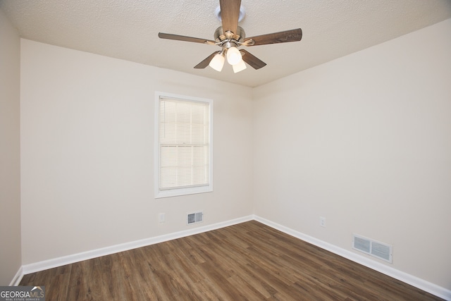 unfurnished room with a textured ceiling, ceiling fan, and dark wood-type flooring