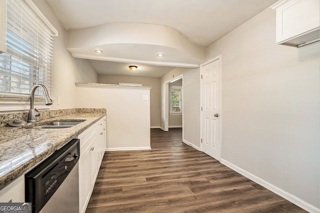 kitchen with dark hardwood / wood-style flooring, light stone counters, sink, dishwasher, and white cabinetry