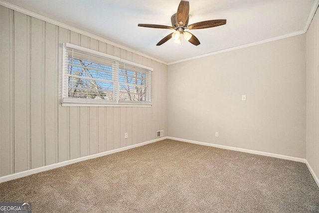 unfurnished room with carpet flooring, ceiling fan, and ornamental molding