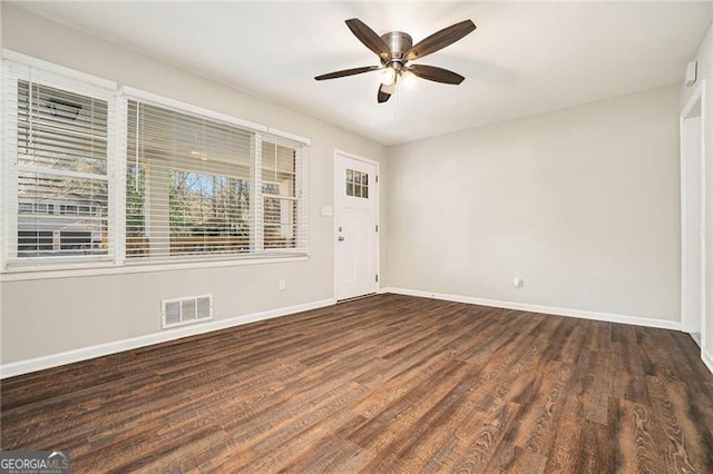 spare room with ceiling fan and dark wood-type flooring