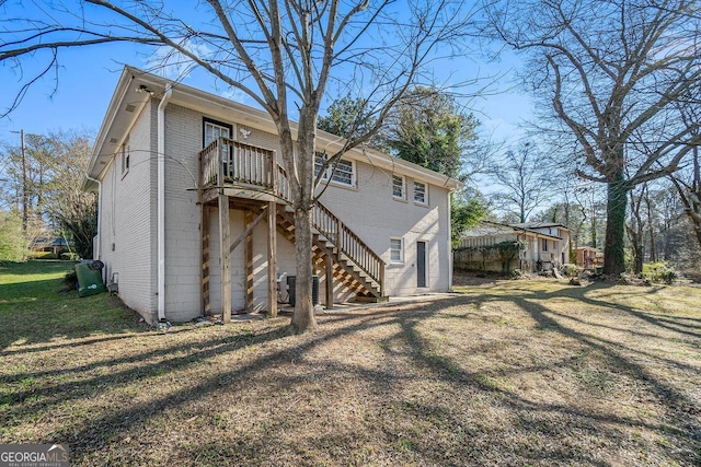 rear view of property featuring a yard