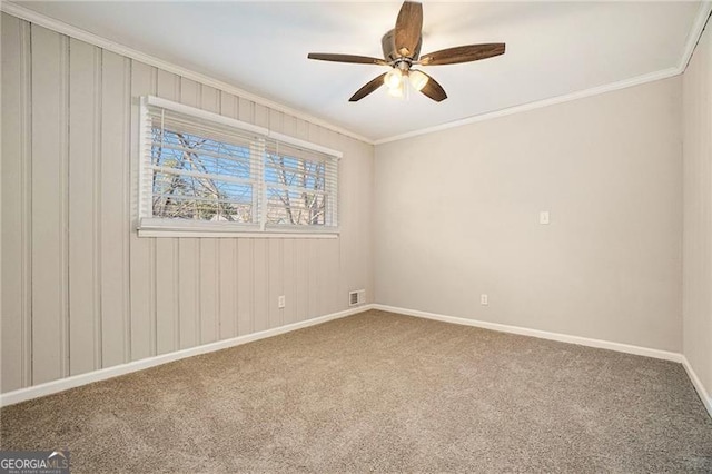 unfurnished room with carpet floors, ceiling fan, and crown molding