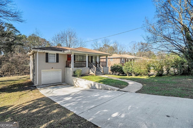 ranch-style house featuring a porch, a garage, and a front yard