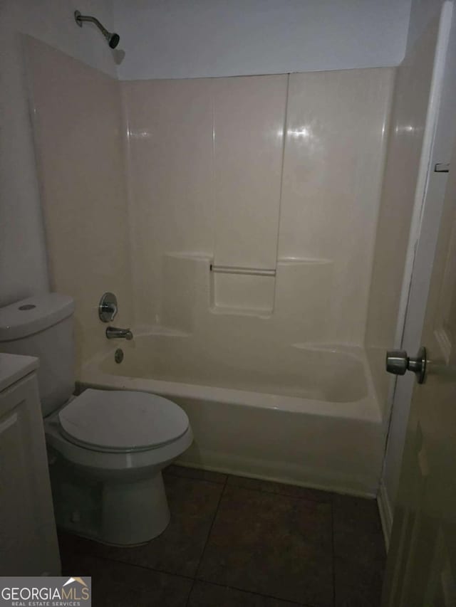 full bathroom with toilet, tile patterned flooring, vanity, and washtub / shower combination