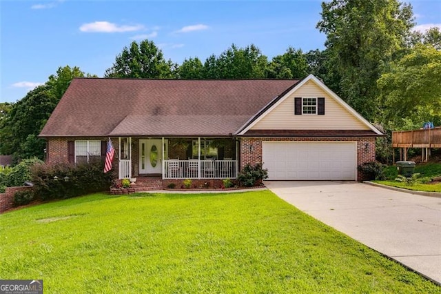 ranch-style home featuring a garage, covered porch, and a front lawn