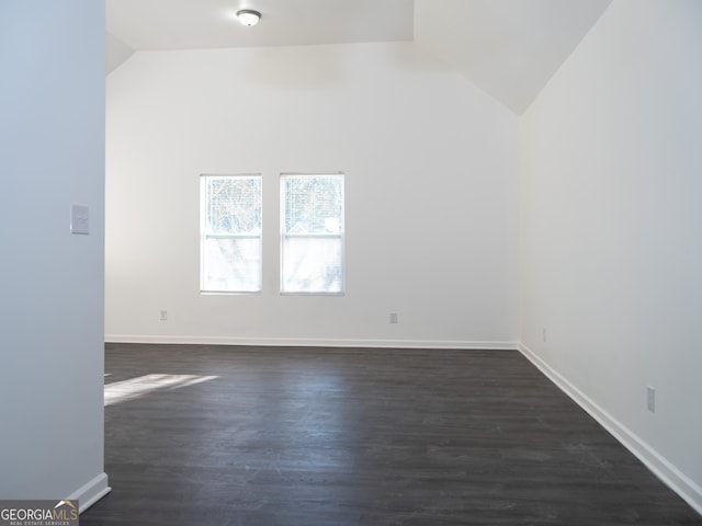 unfurnished room featuring dark hardwood / wood-style flooring and vaulted ceiling