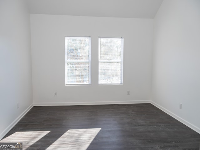 empty room with dark hardwood / wood-style floors