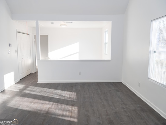 spare room with dark hardwood / wood-style flooring