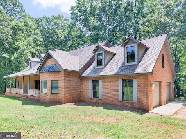 view of front of house with a porch, a garage, and a front yard