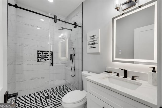 bathroom with an enclosed shower, vanity, and toilet