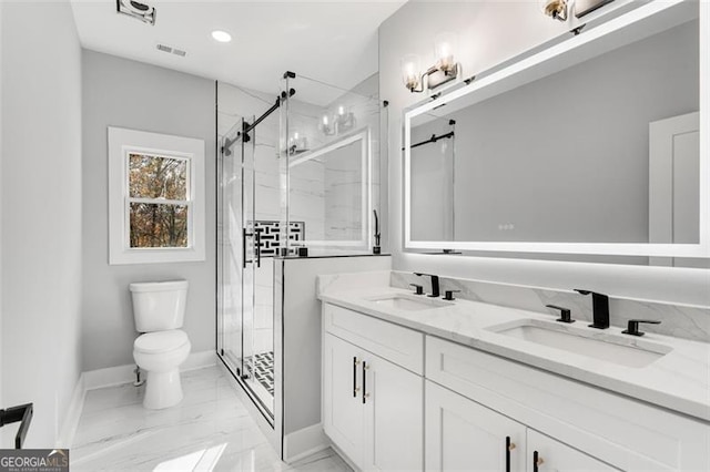 bathroom featuring vanity, an enclosed shower, and toilet