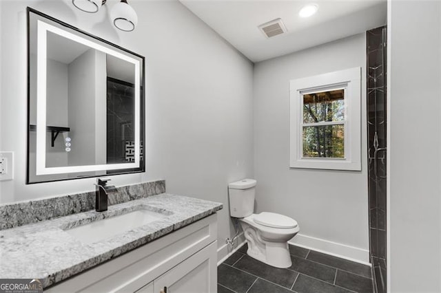 bathroom with tile patterned floors, vanity, and toilet