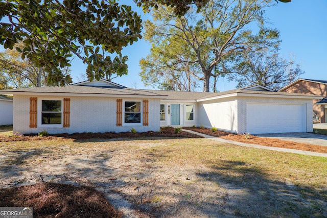 single story home with a garage and a front yard