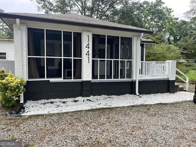 view of side of home featuring a sunroom