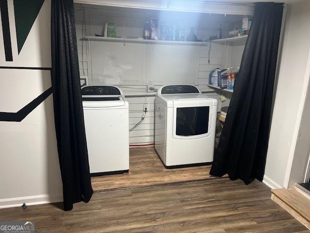 laundry room with dark hardwood / wood-style floors and washing machine and clothes dryer