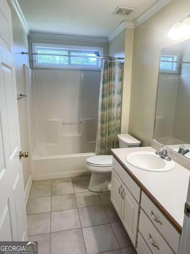 full bathroom with vanity, tile patterned floors, crown molding, toilet, and shower / bath combo with shower curtain