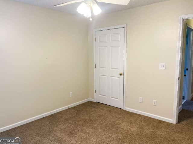 unfurnished bedroom featuring carpet flooring and ceiling fan