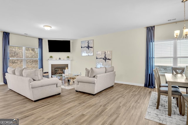 living room featuring a notable chandelier and wood-type flooring