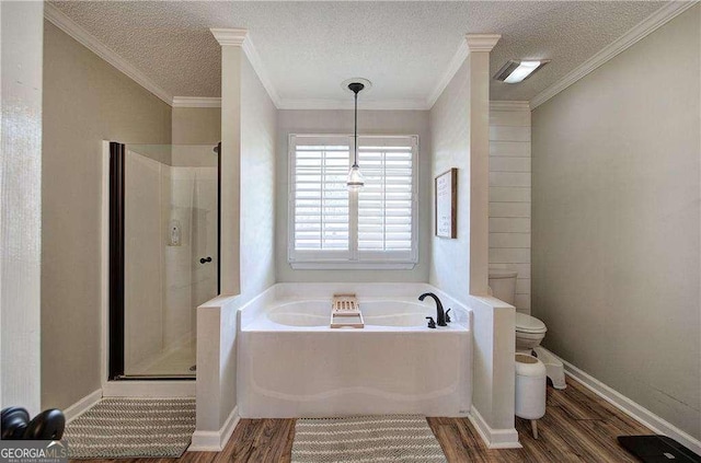 bathroom featuring ornamental molding, a textured ceiling, hardwood / wood-style flooring, shower with separate bathtub, and toilet