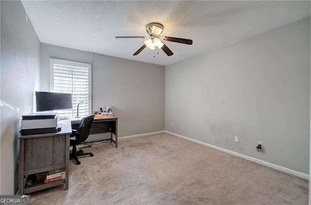 office space with ceiling fan, light colored carpet, and a textured ceiling