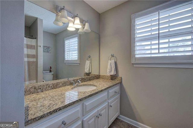 bathroom with vanity and toilet